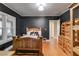 Bedroom with a king bed, closet, wood floors and dark walls for a comforting space at 407 E College E St, Bowdon, GA 30108
