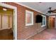 Bright sunroom featuring brick walls, a mosaic-tiled floor, a ceiling fan, and multiple windows at 407 E College E St, Bowdon, GA 30108