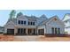 New construction, two-story home featuring a gray exterior, attached two car garage and a covered porch at 4605 Aiden Way, Cumming, GA 30041