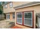 Backyard view featuring a small patio, windows, door, and partial wood fence for privacy at 2039 Oak Park Ln, Decatur, GA 30032