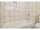 Bathroom featuring a bathtub, tiled shower wall and toilet at 2039 Oak Park Ln, Decatur, GA 30032