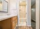 Bathroom featuring a shower with tile, vanity and wood-look flooring at 2039 Oak Park Ln, Decatur, GA 30032