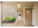 Cozy front entrance featuring a white door, lush plants, and exterior lighting at 2039 Oak Park Ln, Decatur, GA 30032