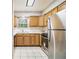 Well-lit kitchen with stainless appliances, wooden cabinets, and tile backsplash at 2039 Oak Park Ln, Decatur, GA 30032