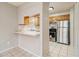 View of the kitchen with tile flooring, stainless refrigerator and wooden cabinets at 2039 Oak Park Ln, Decatur, GA 30032