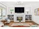 Bright living room featuring a fireplace, hardwood floors, and custom built-in shelving at 259 Sisson Ave, Atlanta, GA 30317