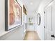 Bright hallway with hardwood floors, modern art, and natural light at 5753 Tillman Way, Powder Springs, GA 30127
