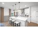 Bright kitchen featuring white cabinets, a central island, and stylish pendant lights at 5753 Tillman Way, Powder Springs, GA 30127