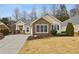 Charming one-story home with stone accents, manicured landscaping, and a welcoming front porch at 6775 Marlow Dr, Cumming, GA 30041