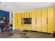 Organized garage space with ample yellow cabinetry, providing abundant storage solutions at 6775 Marlow Dr, Cumming, GA 30041