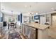 Open kitchen with granite countertops, stainless steel appliances, and a view of the dining area at 6775 Marlow Dr, Cumming, GA 30041
