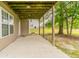 Enjoy the outdoors from this covered back patio, perfect for relaxing or entertaining guests at 725 Signature Trce, Palmetto, GA 30268