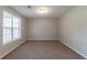 Bright, carpeted bedroom filled with natural light from the window, creating a welcoming atmosphere at 725 Signature Trce, Palmetto, GA 30268