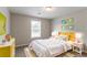 Bedroom features a large window and yellow decor accents at 725 Signature Trce, Palmetto, GA 30268