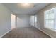 Bright room with plush carpet, fresh paint, and lots of light from the large window at 725 Signature Trce, Palmetto, GA 30268