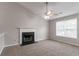 Bright living room featuring a fireplace, neutral walls, carpet, and large window allowing ample natural light at 725 Signature Trce, Palmetto, GA 30268