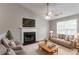 Inviting living room featuring a cozy fireplace, neutral decor, and comfortable seating arrangement at 725 Signature Trce, Palmetto, GA 30268