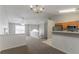 Bright living room with modern ceiling fan, fireplace, and open floor plan to kitchen with stainless steel appliances at 725 Signature Trce, Palmetto, GA 30268