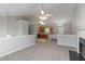 Open-concept living area seamlessly connecting the living room and kitchen with neutral decor and ample lighting at 725 Signature Trce, Palmetto, GA 30268