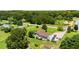 An aerial shot of a single story home with a long driveway surrounded by lush greenery and several parked vehicles at 107 Bowen Rd, Stockbridge, GA 30281