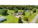 Aerial view of a charming property with lush greenery, and a beautiful home and sheds at 107 Bowen Rd, Stockbridge, GA 30281