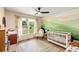 A well-lit baby bedroom with a mountain scene painted on the wall with a crib at 107 Bowen Rd, Stockbridge, GA 30281