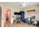 Bedroom featuring hardwood floors, a ceiling fan, and a desk with dual monitors at 107 Bowen Rd, Stockbridge, GA 30281