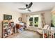 A well-lit baby bedroom with a mountain scene painted on the wall with a crib at 107 Bowen Rd, Stockbridge, GA 30281