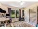 Well-lit bedroom with hardwood floors, a sunny window, and workout and crafting equipment at 107 Bowen Rd, Stockbridge, GA 30281