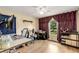 Bright bedroom featuring hardwood floors, a ceiling fan, and a sunlit window at 107 Bowen Rd, Stockbridge, GA 30281