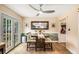 Bright dining area with large windows and a modern ceiling fan, adjacent to the kitchen at 107 Bowen Rd, Stockbridge, GA 30281