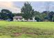 Charming single-story home with a spacious lawn, mature trees, and a welcoming front porch at 107 Bowen Rd, Stockbridge, GA 30281