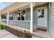 Close up of the front porch featuring white railings, hanging plants, and a welcoming front door at 107 Bowen Rd, Stockbridge, GA 30281