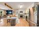 Bright kitchen with stainless appliances, painted cabinets, and a breakfast bar overlooking the living area at 107 Bowen Rd, Stockbridge, GA 30281