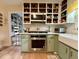 Bright kitchen featuring stainless steel appliances, open shelving, and a convenient pantry at 107 Bowen Rd, Stockbridge, GA 30281