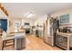 Updated kitchen featuring stainless steel appliances, white cabinets, and an eat-in island at 107 Bowen Rd, Stockbridge, GA 30281