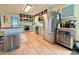 Well-organized kitchen with stainless steel appliances, custom cabinets, and laminate wood flooring at 107 Bowen Rd, Stockbridge, GA 30281