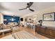 Open-concept living room with wood floors, ceiling fans, and a view into the eat-in kitchen at 107 Bowen Rd, Stockbridge, GA 30281