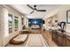 Bright and open living room with hardwood floors and large windows overlooking the front yard at 107 Bowen Rd, Stockbridge, GA 30281