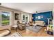 Spacious living room with natural light, modern furniture, wood-look floors, and decorative rugs at 107 Bowen Rd, Stockbridge, GA 30281