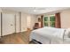 Comfortable main bedroom with hardwood floors, backyard views, and attached bathroom at 107 Bowen Rd, Stockbridge, GA 30281