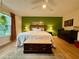 Spacious main bedroom featuring an ornate storage chest, ensuite lamps, and a ceiling fan at 107 Bowen Rd, Stockbridge, GA 30281
