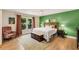 Relaxing main bedroom with natural light, hardwood floors, and stylish decor at 107 Bowen Rd, Stockbridge, GA 30281