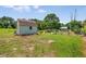 Backyard shed featuring a storage area and a garden, set in a grassy yard with lush greenery at 107 Bowen Rd, Stockbridge, GA 30281