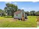 Outdoor shed on a grassy lawn with some landscaping and mature trees around at 107 Bowen Rd, Stockbridge, GA 30281