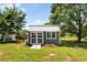Backyard shed featuring modern construction, set in a grassy yard with mature trees and concrete blocks at 107 Bowen Rd, Stockbridge, GA 30281