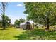 Backyard shed featuring modern construction, set in a grassy yard with mature trees at 107 Bowen Rd, Stockbridge, GA 30281