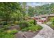 Beautiful backyard with a stone patio, hot tub, mature trees, and outdoor seating for entertaining at 1135 Timberland Se Dr, Marietta, GA 30067