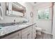 Bright bathroom with granite countertop, white cabinets, tile flooring and decorative elements at 1135 Timberland Se Dr, Marietta, GA 30067