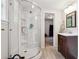 Clean bathroom featuring a glass shower enclosure, modern fixtures, and a wood-finished vanity at 1135 Timberland Se Dr, Marietta, GA 30067